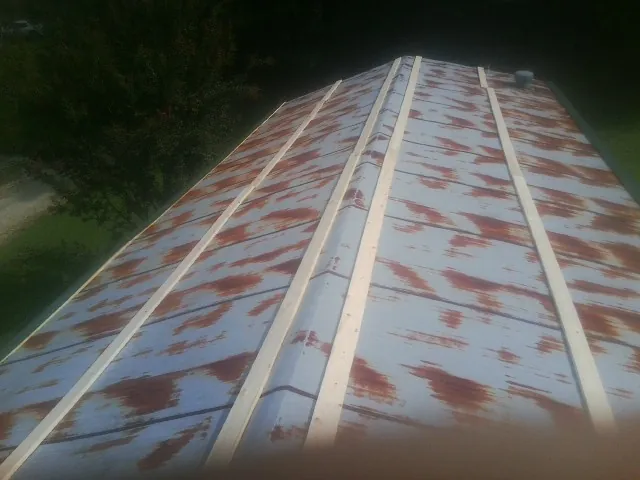 Rusted metal roof panels with new wood purlins before replacement — Storm Damage Roof Repair in Taloga by Roofing Brothers